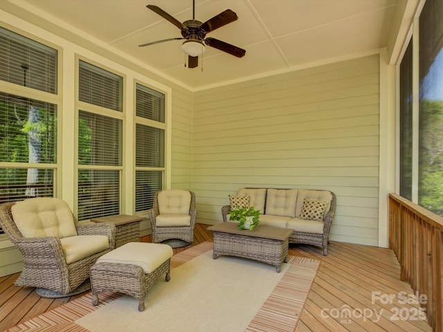 sunroom featuring a ceiling fan and outdoor lounge area