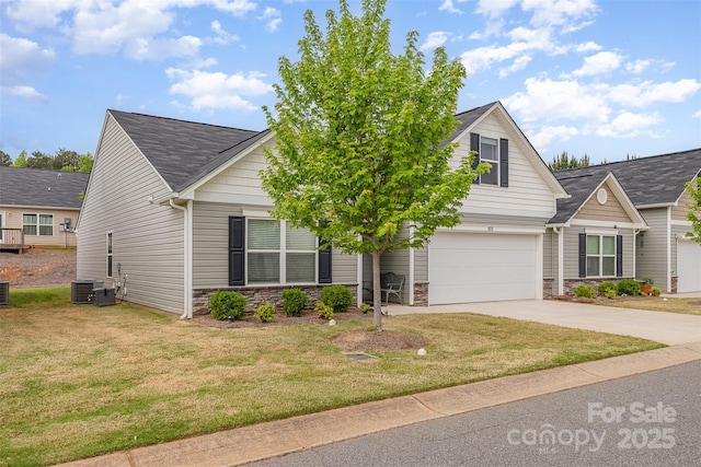 1125 Silvertrace Dr, Salisbury, NC 28144 - view of front of house with roof with shingles, cooling unit, a front lawn, concrete driveway, and stone siding