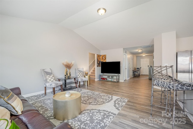 1125 Silvertrace Dr, Salisbury, NC 28144 - living area with visible vents, wood finished floors, baseboards, lofted ceiling, and stairs