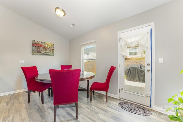 1125 Silvertrace Dr, Salisbury, NC 28144 - dining space featuring baseboards, visible vents, wood finished floors, and lofted ceiling