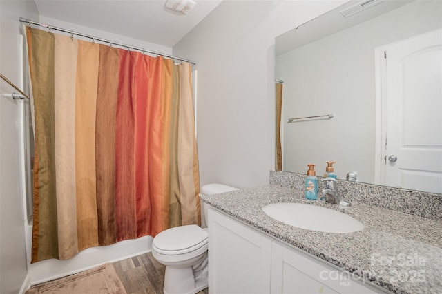1125 Silvertrace Dr, Salisbury, NC 28144 - bathroom with visible vents, wood finished floors, toilet, and vanity