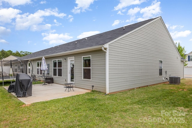 1125 Silvertrace Dr, Salisbury, NC 28144 - back of property with a lawn, a trampoline, a patio area, and central air condition unit