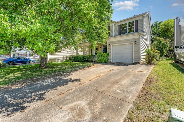 view of front of property featuring a garage, driveway, and a front yard