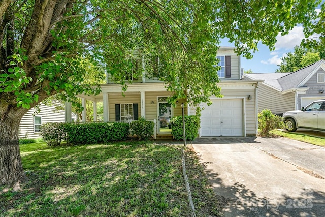 view of property hidden behind natural elements with driveway, a porch, and a garage