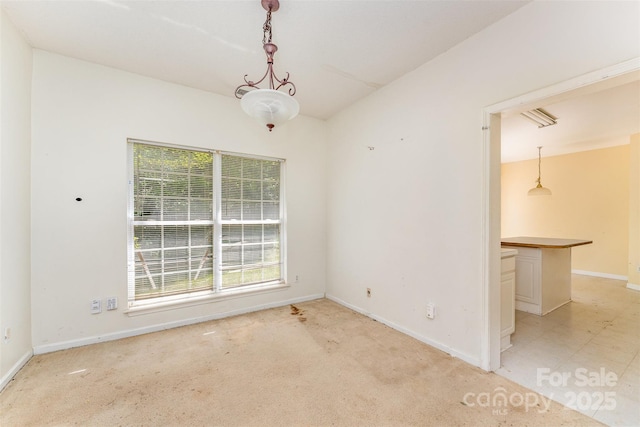 spare room featuring baseboards and light colored carpet