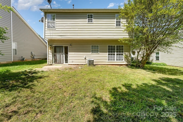 rear view of house with a yard and central air condition unit