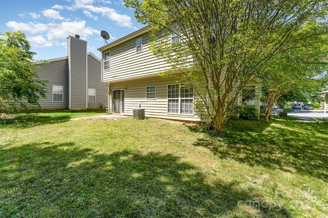 rear view of property with a lawn