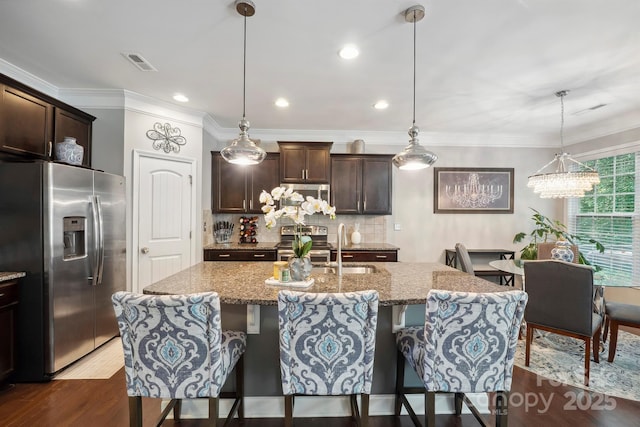 13402 David Jennings Ave, Charlotte, NC 28213 - kitchen with visible vents, a breakfast bar area, backsplash, and stainless steel appliances