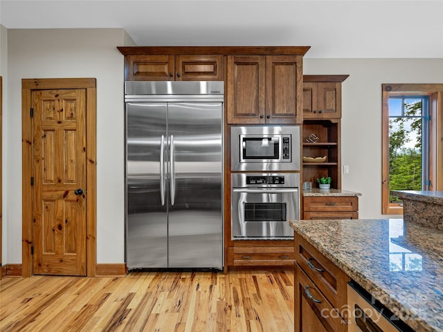 14 Sweet Gum Hl, Fletcher, NC 28732 - kitchen featuring built in appliances, light wood-style floors, stone counters, and open shelves