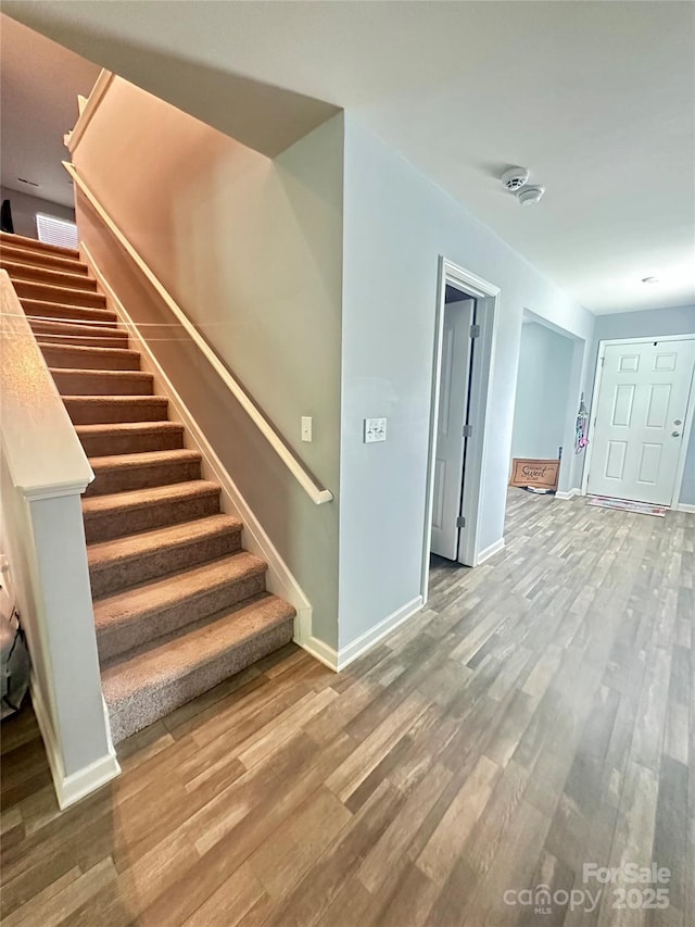 1070 Glenbriar Ct, Woodleaf, NC 27054 - stairs with wood finished floors and baseboards