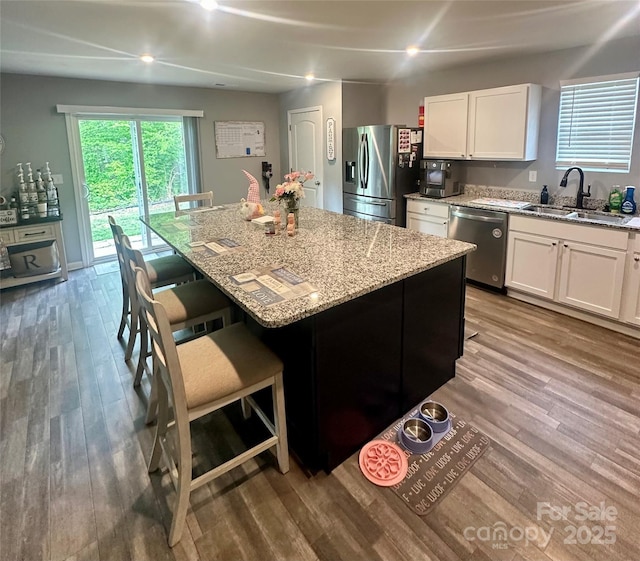 1070 Glenbriar Ct, Woodleaf, NC 27054 - kitchen featuring appliances with stainless steel finishes, light stone counters, white cabinetry, and a sink
