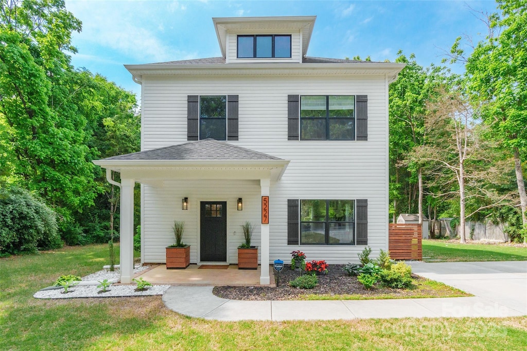 5227 Pinebrook Dr, Charlotte, NC 28208 - traditional style home with fence, roof with shingles, and a front yard