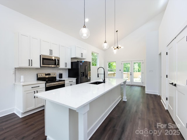 3007 W Blvd, Charlotte, NC 28208 - kitchen featuring appliances with stainless steel finishes, a sink, dark wood finished floors, white cabinetry, and high vaulted ceiling