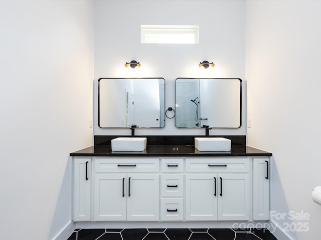 3007 W Blvd, Charlotte, NC 28208 - bathroom with double vanity, tile patterned flooring, a shower, and baseboards