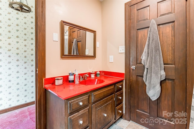 bathroom with vanity and wallpapered walls