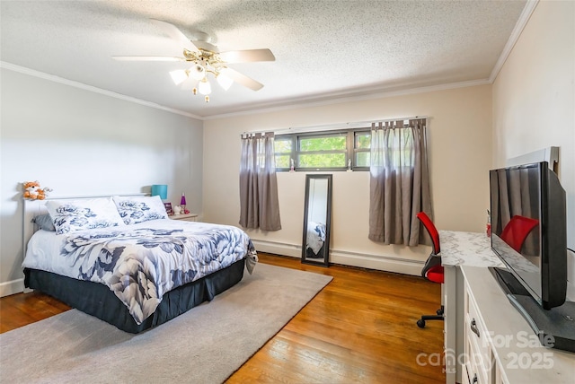 bedroom featuring wood finished floors, a textured ceiling, ceiling fan, and ornamental molding