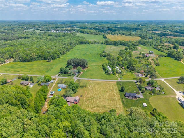 bird's eye view with a view of trees and a rural view