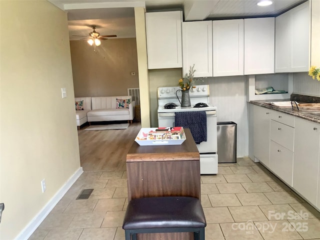 439 17th St, Cramerton, NC 28032 - kitchen with white range with electric cooktop, light tile patterned flooring, a ceiling fan, white cabinets, and baseboards