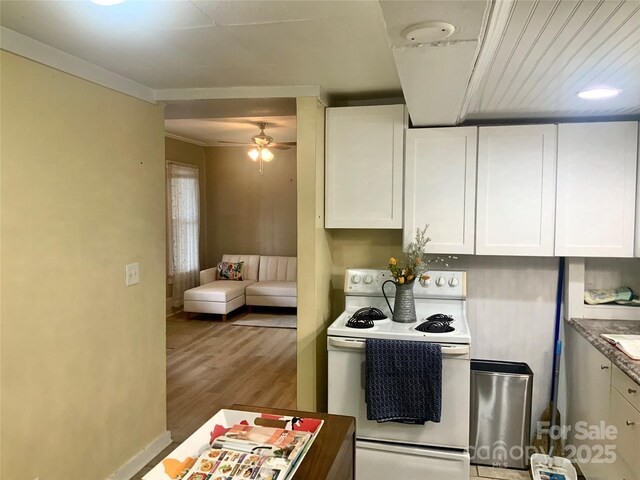 439 17th St, Cramerton, NC 28032 - kitchen featuring white range with electric stovetop, white cabinets, ceiling fan, wood finished floors, and crown molding
