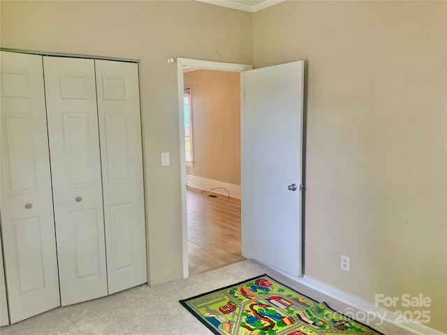 439 17th St, Cramerton, NC 28032 - unfurnished bedroom featuring ornamental molding, a closet, and carpet