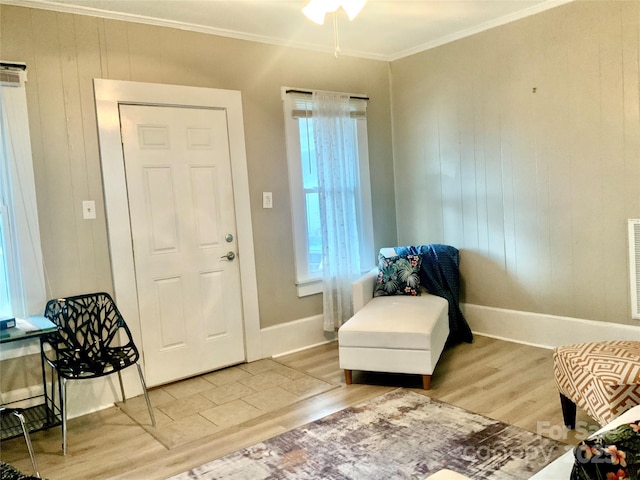 439 17th St, Cramerton, NC 28032 - entryway with light wood-type flooring, crown molding, plenty of natural light, baseboards, and wood walls