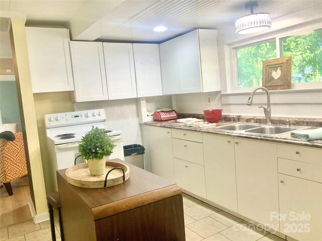 439 17th St, Cramerton, NC 28032 - kitchen featuring a sink, light tile patterned flooring, white range with electric cooktop, white cabinetry, and light countertops