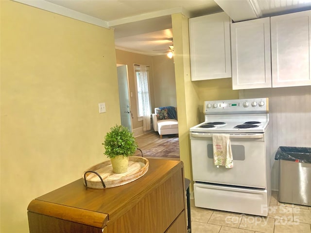 439 17th St, Cramerton, NC 28032 - kitchen featuring white electric stove, white cabinetry, ceiling fan, light tile patterned floors, and ornamental molding
