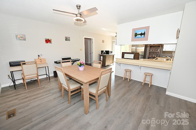 2263 Starbrooke Dr, Newton, NC 28658 - dining room with baseboards, ceiling fan, and wood finished floors