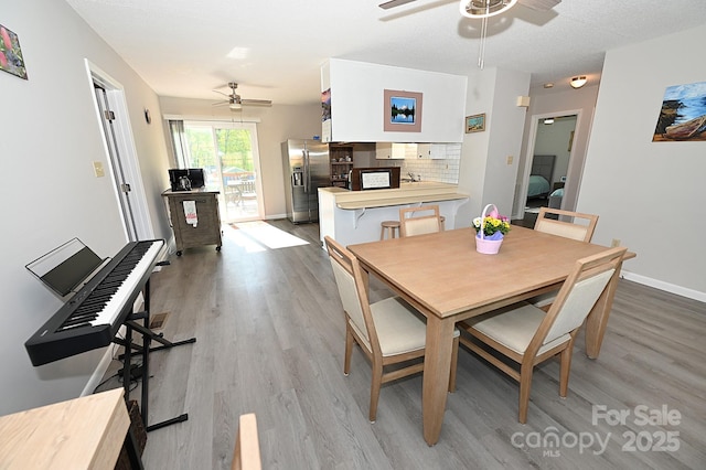 2263 Starbrooke Dr, Newton, NC 28658 - dining space with light wood-type flooring, baseboards, and ceiling fan