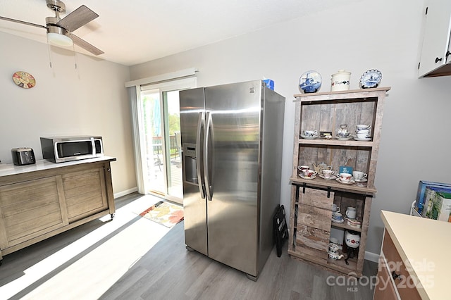 2263 Starbrooke Dr, Newton, NC 28658 - kitchen featuring baseboards, a ceiling fan, stainless steel appliances, and light wood-style flooring