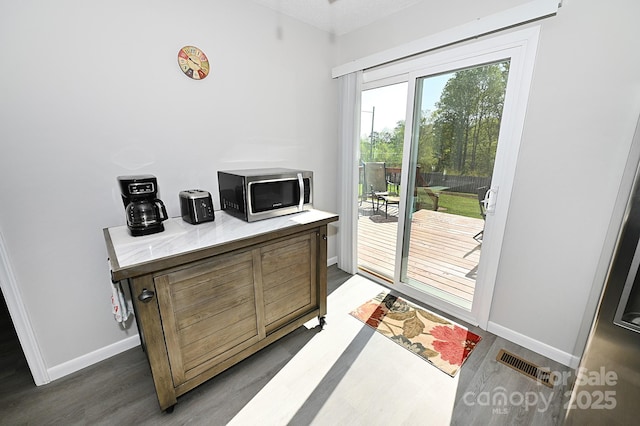 2263 Starbrooke Dr, Newton, NC 28658 - doorway to outside with baseboards, wood finished floors, and visible vents