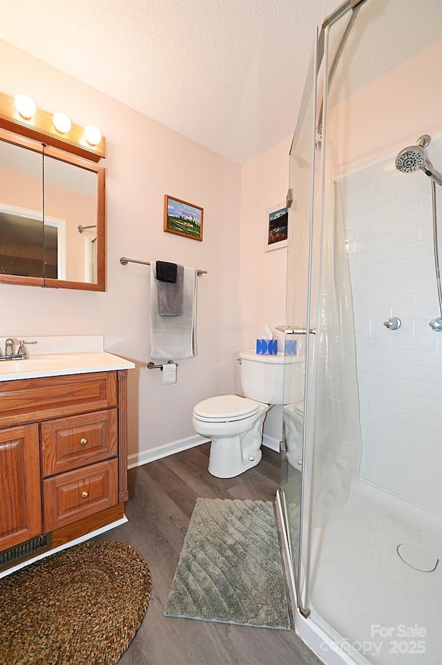 2263 Starbrooke Dr, Newton, NC 28658 - full bath with vanity, wood finished floors, toilet, a textured ceiling, and a shower stall