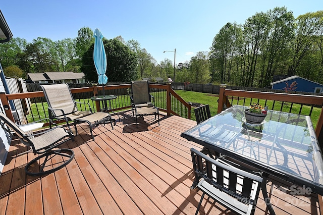 2263 Starbrooke Dr, Newton, NC 28658 - wooden deck featuring a lawn, outdoor dining area, and a fenced backyard
