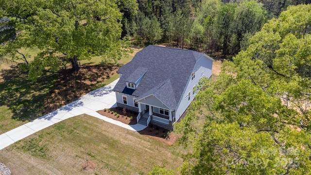 drone / aerial view featuring a forest view