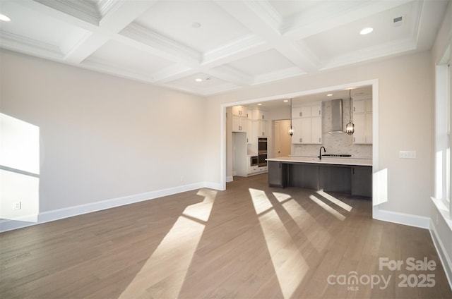 unfurnished living room with beamed ceiling, baseboards, recessed lighting, and coffered ceiling