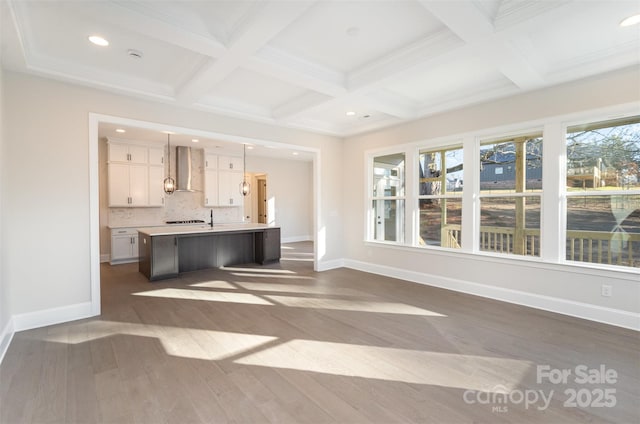 unfurnished living room featuring beamed ceiling, baseboards, dark wood-style flooring, and coffered ceiling