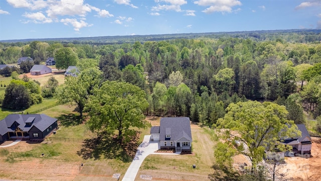 birds eye view of property with a wooded view