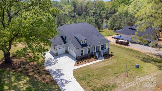 birds eye view of property featuring a view of trees