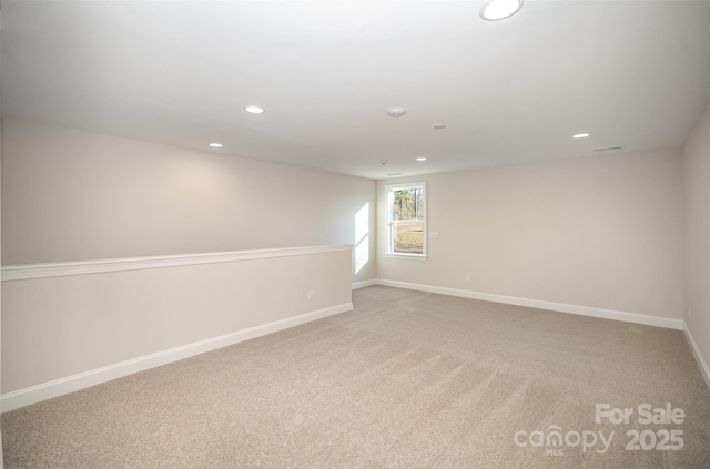unfurnished room with baseboards, light carpet, and recessed lighting