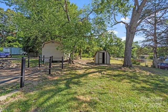 2609 Lowell Rd, Gastonia, NC 28054 - view of yard featuring an outdoor structure, fence, and a storage shed