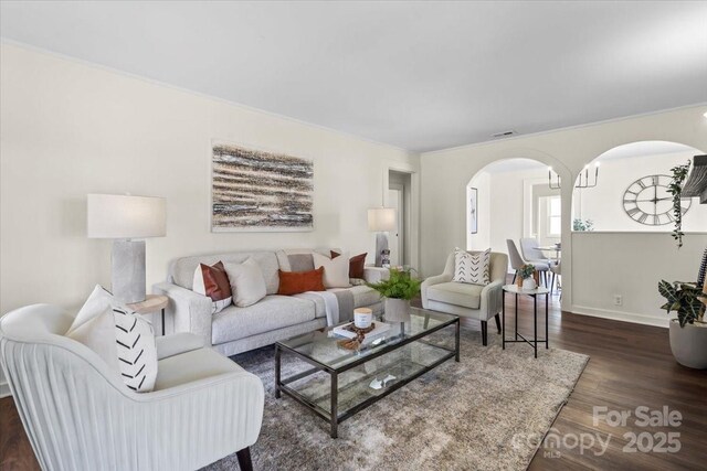 2609 Lowell Rd, Gastonia, NC 28054 - living room with arched walkways, visible vents, baseboards, and dark wood-style flooring
