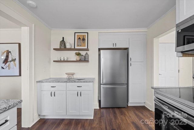 2609 Lowell Rd, Gastonia, NC 28054 - kitchen featuring white cabinets, dark wood finished floors, light stone counters, ornamental molding, and appliances with stainless steel finishes