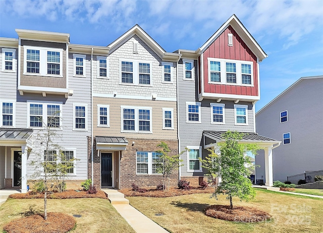 147 Morning Gap Pkwy, Fort Mill, SC 29715 - view of front of property with board and batten siding, a standing seam roof, and brick siding