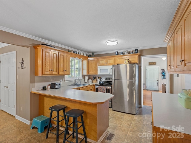 5159 Taxahaw Rd, Lancaster, SC 29720 - kitchen with a peninsula, ornamental molding, a sink, and appliances with stainless steel finishes