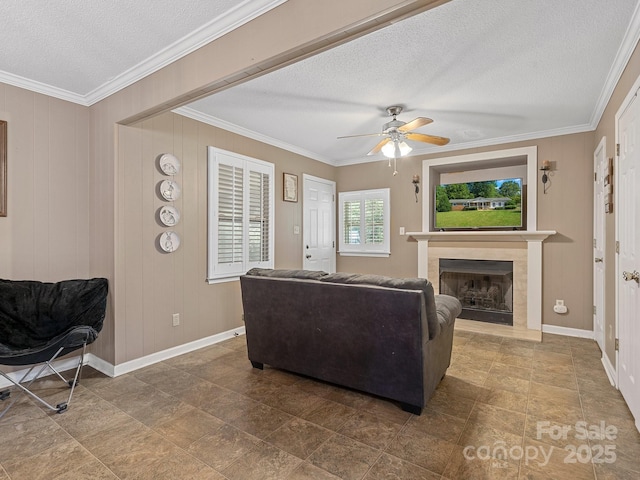 5159 Taxahaw Rd, Lancaster, SC 29720 - living room featuring a ceiling fan, a textured ceiling, a fireplace with raised hearth, baseboards, and ornamental molding