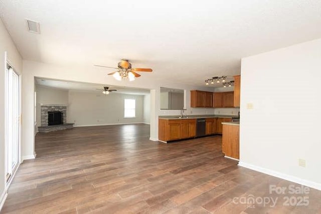 1965 Leesburg Dr, Clover, SC 29710 - kitchen with ceiling fan, dishwasher, baseboards, open floor plan, and dark wood-type flooring