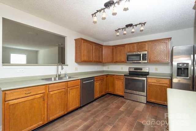 1965 Leesburg Dr, Clover, SC 29710 - kitchen featuring brown cabinetry, appliances with stainless steel finishes, a sink, light countertops, and dark wood-style floors