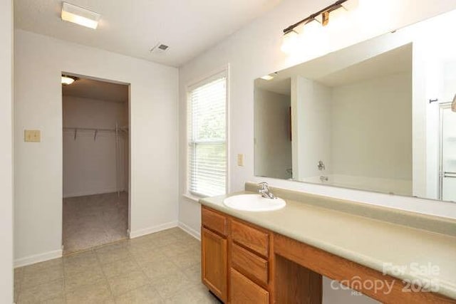 1965 Leesburg Dr, Clover, SC 29710 - full bath featuring vanity, baseboards, tile patterned floors, and a spacious closet