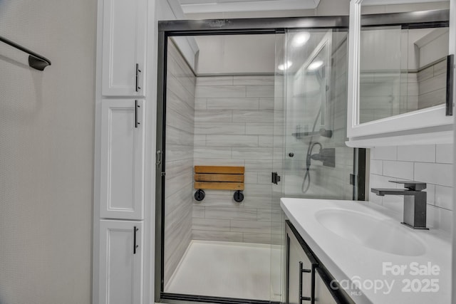 bathroom featuring a shower stall, vanity, and decorative backsplash