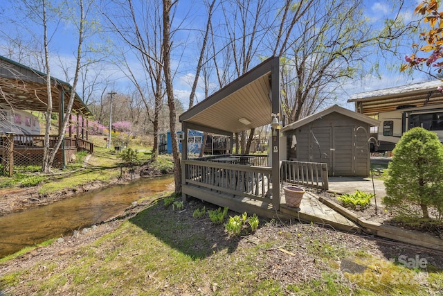 deck with a shed and an outbuilding